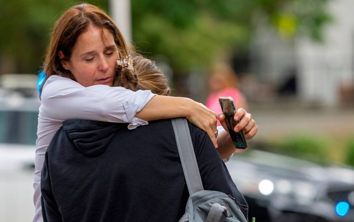 People console one another after being released from a lockdown area on South Road after a report of an armed and dangerous person on the University of North Carolina campus on Monday, August 28. 2023 in Chapel Hill, N.C.