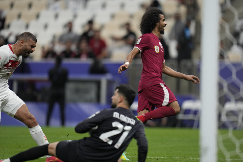 Qatar's Akram Afif, right, celebrates after scoring his side's third goal during the Asian Cup Group A soccer match between Qatar and Lebanon at the Lusail Stadium in Lusail, Qatar, Friday, Jan. 12, 2024. (AP Photo/Aijaz Rahi)