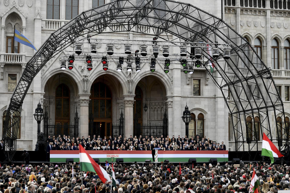 Hungary's right-wing populist prime minister, Viktor Orban addresses thousands of supporters as they gather in Budapest, Hungary, Tuesday, March 15, 2022. The so-called "peace march" was a show of strength by Orban's supporters ahead of national elections scheduled for April 3, while a coalition of six opposition parties also held a rally in the capital. (AP Photo/Anna Szilagyi)