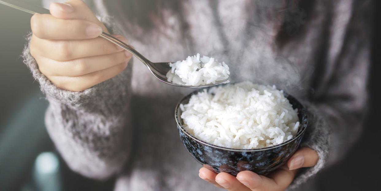 midsection of woman holding rice in bowl