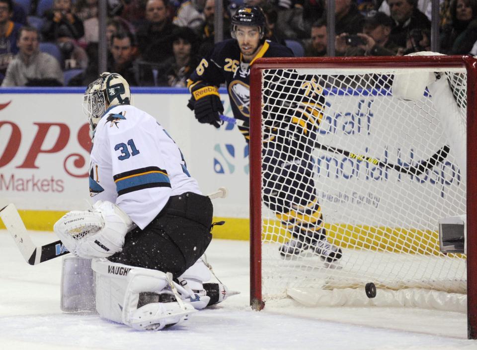 San Jose Sharks goaltender Antti Neimi (31), of Finland, is scored on by Buffalo Sabres' Cody Hodgson, not seen, as Sabres left winger Matt Moulson (26) watches during the first period of an NHL hockey game in Buffalo, N.Y., Friday, Feb. 28, 2014. (AP Photo/Gary Wiepert)