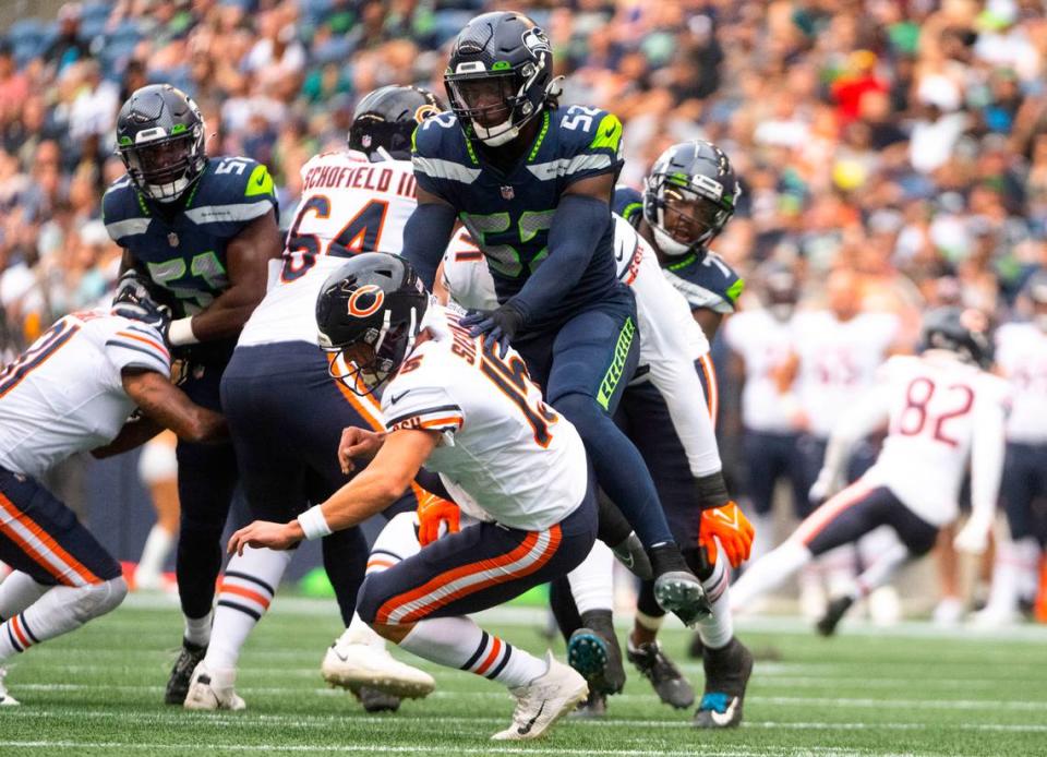 Seattle Seahawks defensive end Darrell Taylor (52) tackles Chicago Bears quarterback Trevor Simian (15) during the first half of the Seahawks second preseason game at Lumen Field in Seattle, Wash. on August 18, 2022. Cheyenne Boone/Cheyenne Boone/The News Tribune