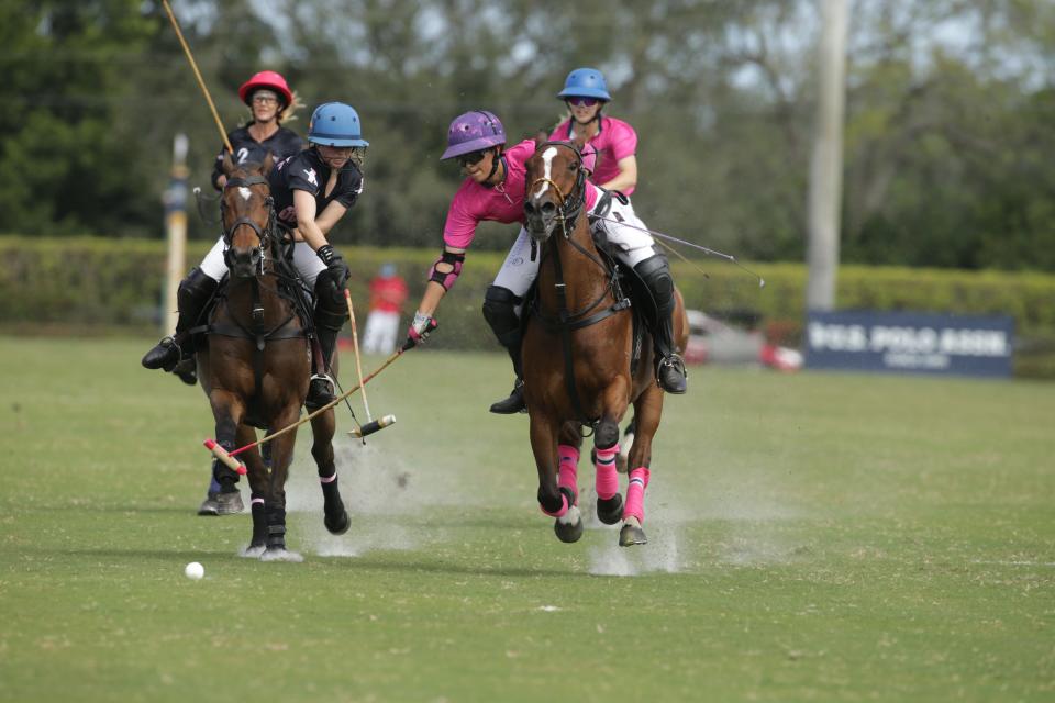 Valentina Tarazona of Buena Vibra, the youngest player to win this championship, and Winnie Branscum of 90210 battle for the ball during the rain-delayed U.S. Open Women's Polo Championship Friday at the National Polo Center.