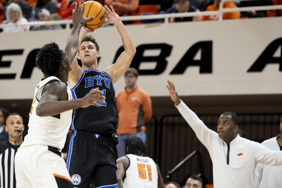 BYU guard Trevin Knell (21) shoots over Oklahoma State forward Eric Dailey Jr. (2) in the first half of the NCAA college basketball game, Saturday, Feb. 17, 2024, in Stillwater, Okla. (AP Photo/Mitch Alcala)