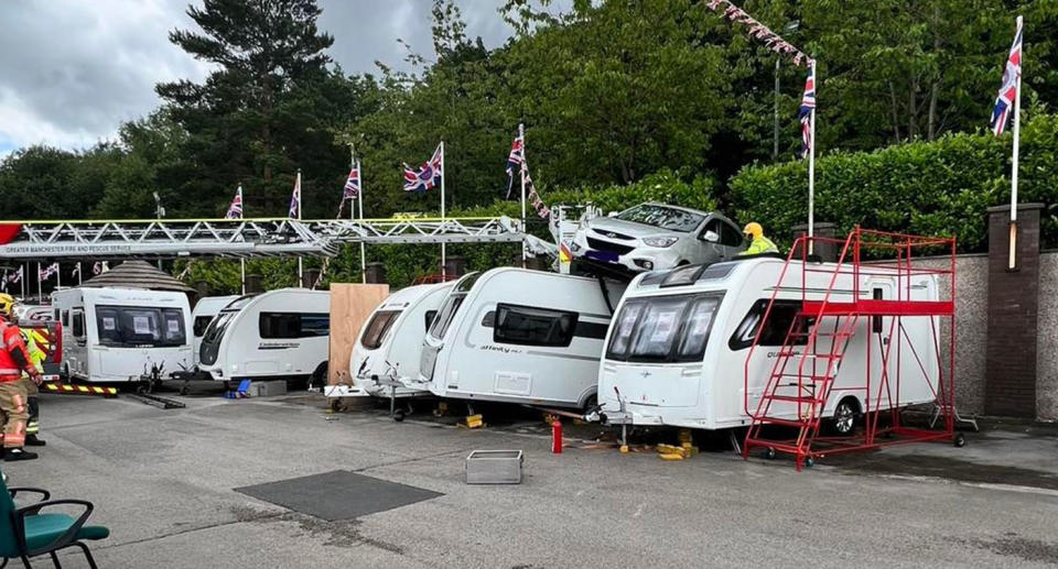 A car managed to crash on top of a caravan and motorhome in the UK. Source: Glossop Fire Station