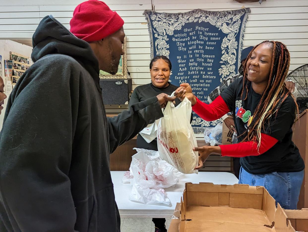 Destiny Harde, right, founded the giveaway ministry DreamByRoyal, during the COVID epidemic. Harde is pictured here conducting a Thanksgiving food drive at the Drop-In Center/Light of Christ Church in Canton. Assisting is her sister, Amirah Harde, center.