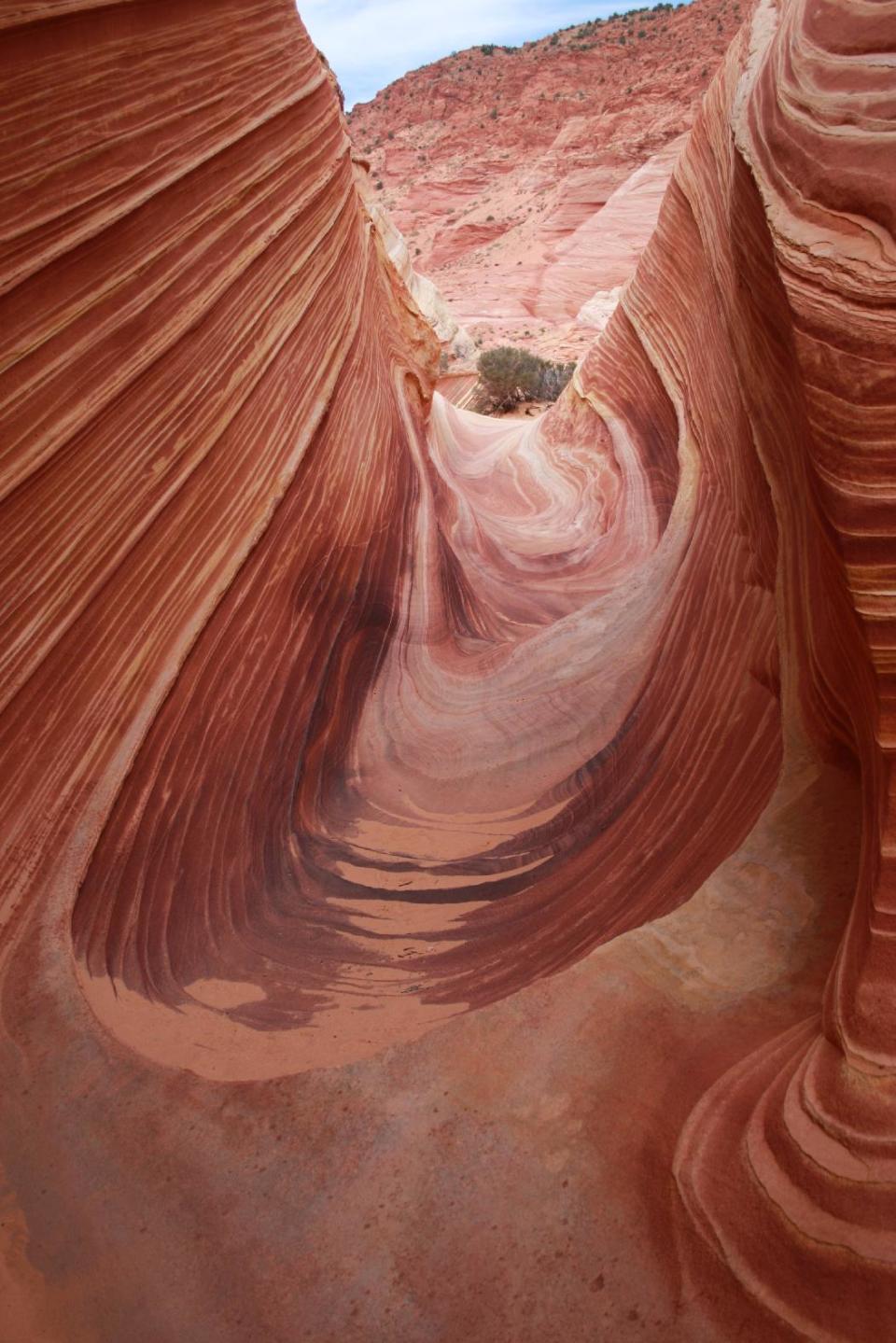 This May 28, 2013 photo shows a section of a rock formation known as The Wave, part of the land that comprises the Vermilion Cliffs National Monument in Arizona. Access is limited to the site located in the Utah-Arizona desert backcountry, with just 20 hikers allowed in per day. Permits are given by lottery. (AP Photo/Brian Witte)