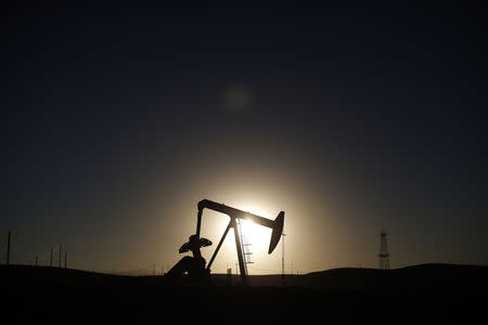 A pump jack is seen at sunrise near Bakersfield, California October 14, 2014. REUTERS/Lucy Nicholson/Files
