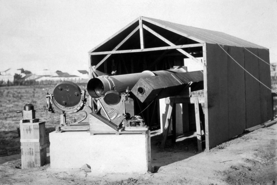 Photograph (bromide print) showing the instruments used by the British expedition sent to observe total solar eclipse on 29 May 1919 from Sobral in Brazil. Sir Arthur Eddington at Cambridge University organised the eclipse trip to try and test Einstein's Theory of Relativity. During the event, two heliostats with moveable mirrors were used to direct images of the eclipsed Sun into a pair of horizontal telescopes. Measurement of photographs taken through these instruments was checked for any deflection of star positions adjacent to the Sun. Einstein suggested that the large mass of a star like our Sun would bend the path of any starlight if it passed close-by. <span class="copyright">SSPL/Getty Images</span>