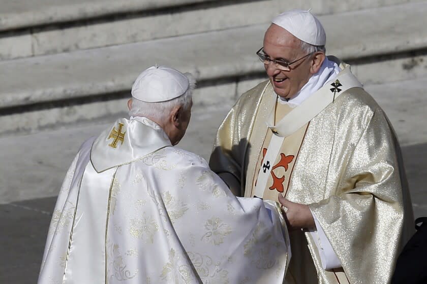 FILE - Pope Emeritus Benedict XVI, left, greets Pope Francis prior to the start of the beatification ceremony of Pope Paul VI and a mass for the closing of a two-week synod on family issues, in St. Peter's Square at the Vatican, Sunday, Oct. 19, 2014. Pope Francis has said that if and when he ever retires, he wouldn't live in the Vatican or return to his native Argentina but would like to find a church in Rome where he could continue hearing confessions. "I'm the bishop of Rome, in this case the emeritus Bishop of Rome," Francis said in an interview broadcast Tuesday, July 12, 2022 with Spanish-language broadcaster Univision. (AP Photo/Gregorio Borgia, File)