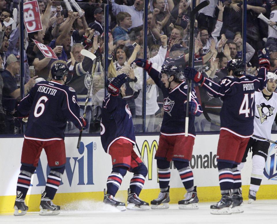 Columbus Blue Jackets' Nikita Nikitin, left to right, of Russia, Boone Jenner, Ryan Johansen and Dalton Prout celebrate their goal against the Pittsburgh Penguins during the first period of a first-round NHL playoff hockey game Monday, April 21, 2014, in Columbus, Ohio. (AP Photo/Jay LaPrete)