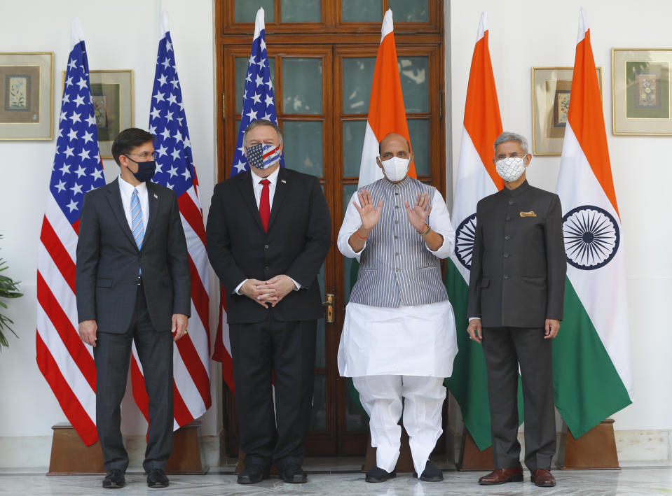 U.S. Secretary of State Mike Pompeo, second left, and Secretary of Defence Mark Esper, left, stand for photographs with Indian Foreign Minister Subrahmanyam Jaishankar, right, and Defence Minister Rajnath Singh ahead of their meeting at Hyderabad House in New Delhi, India, Tuesday, Oct. 27, 2020. In talks on Tuesday with their Indian counterparts, Pompeo and Esper are to sign an agreement expanding military satellite information sharing and highlight strategic cooperation between Washington and New Delhi with an eye toward countering China. (Adnan Abidi/Pool via AP)