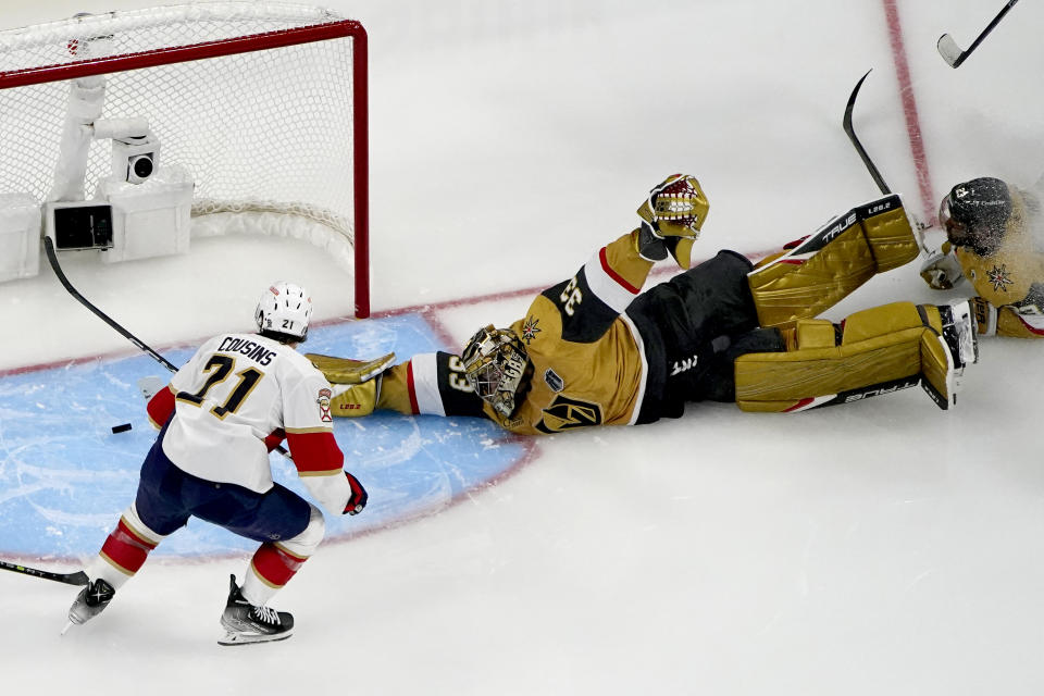 Vegas Golden Knights goaltender Adin Hill (33) blocks a shot on goal by Florida Panthers center Nick Cousins (21) during the second period of Game 1 of the NHL hockey Stanley Cup Finals, Saturday, June 3, 2023, in Las Vegas. (AP Photo/John Locher)