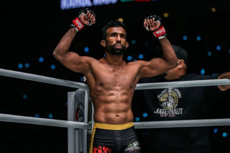 Rahul Raju raises his arms in the ring