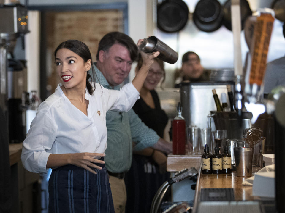 NEW YORK, NY - MAY 31: U.S. Rep. Alexandria Ocasio-Cortez (D-NY) shakes a margarita behind the bar at the Queensboro Restaurant, May 31, 2019 in the Queens borough of New York City. Ocasio-Cortez participated in an event to raise awareness for the One Fair Wage campaign, which calls to raise the minimum wage for tipped workers to a full minimum wage at the federal level. (Photo by Drew Angerer/Getty Images)