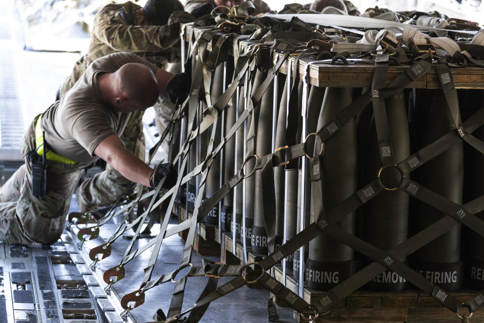 FILE - Airmen push over 8,000 pounds of 155 mm shells ultimately bound for Ukraine onto a C-17 aircraft for transport, April 29, 2022, at Dover Air Force Base, Del. One year ago, President Joe Biden braced for the worst as Russia massed troops in preparation to invade Ukraine. But as Russia’s deadly invasion reaches the one year mark, Kyiv stands and Ukraine has exceeded even its own expectations. The effort was buoyed by a U.S.-led alliance that’s equipped Ukrainian forces while keeping the government in Kyiv afloat with direct assistance. (AP Photo/Alex Brandon, File)