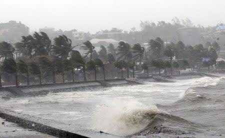 Strong winds and waves brought by Typhoon Hagupit pound the seawall in Legazpi City, Albay province southern Luzon December 7, 2014. REUTERS/Stringer