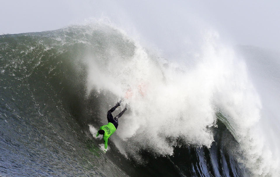 Ben Wilkinson goes tumbling into a wave during the third heat of the first round of the Mavericks Invitational big wave surf contest Friday, Jan. 24, 2014, in Half Moon Bay, Calif. (AP Photo/Eric Risberg)