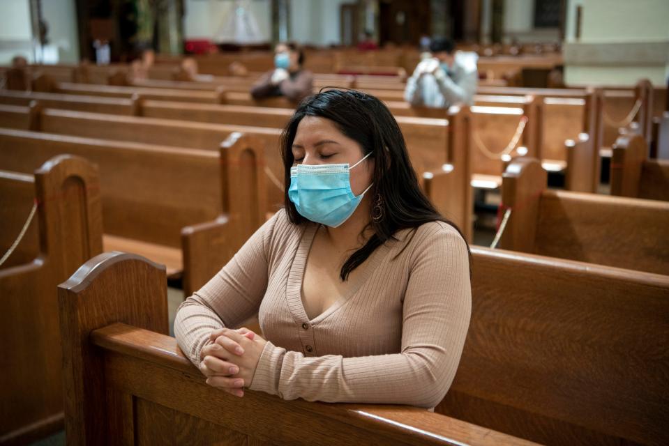 Monica Asitimbay prays at Holy Trinity Church in Hackensack, New Jersey, on Sunday, May 17, 2020, the first the day the church reopened during the coronavirus pandemic.