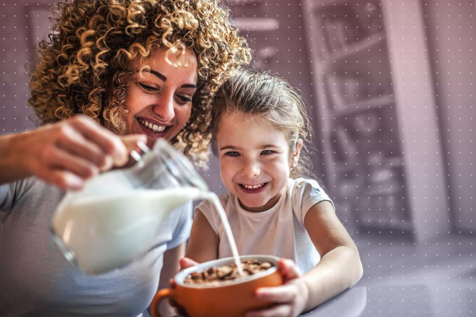 parent and child eating breakfast together