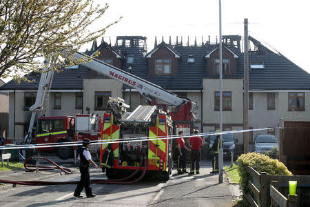 Firefighters and police secure the street at scene of a large fire in a residential care home in Connington Crescent, Chingford, north-east London, Britain, April 20, 2018. REUTERS/Chris Radburn