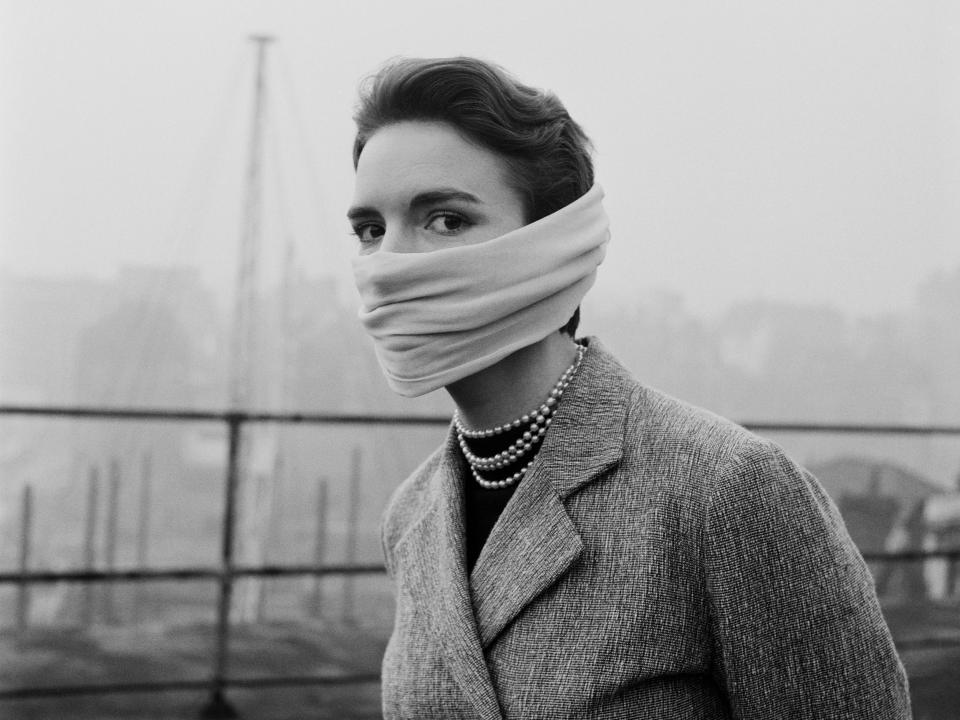 Julie Harrison of the Hulton Press tries out a protective mask to combat the effects of London's smog.