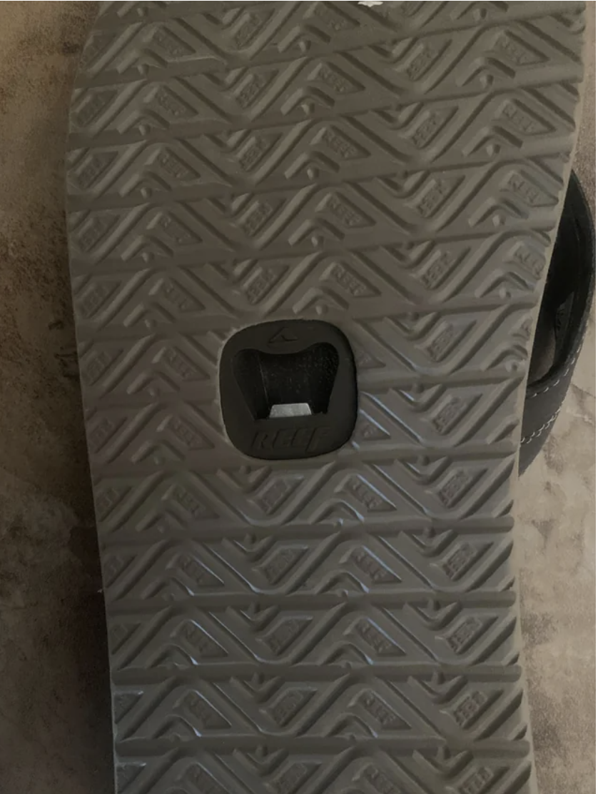 Bottle opener on the bottom of a flip flop