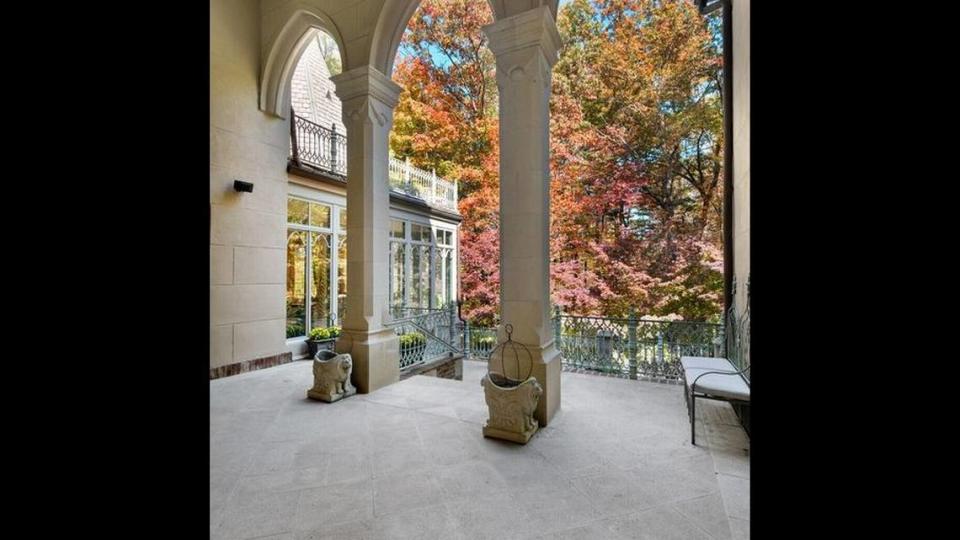 A Venetian portico with 25-foot arches and large cast-stone columns graces the front entrance to the home.