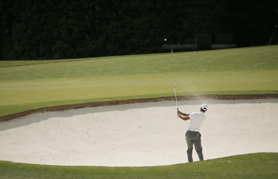 Tiger Woods of the U.S. hits out of a sand trap and onto the fourth green during first round play of the Masters golf tournament at the Augusta National Golf Course in Augusta, Georgia April 9, 2015. REUTERS/Brian Snyder