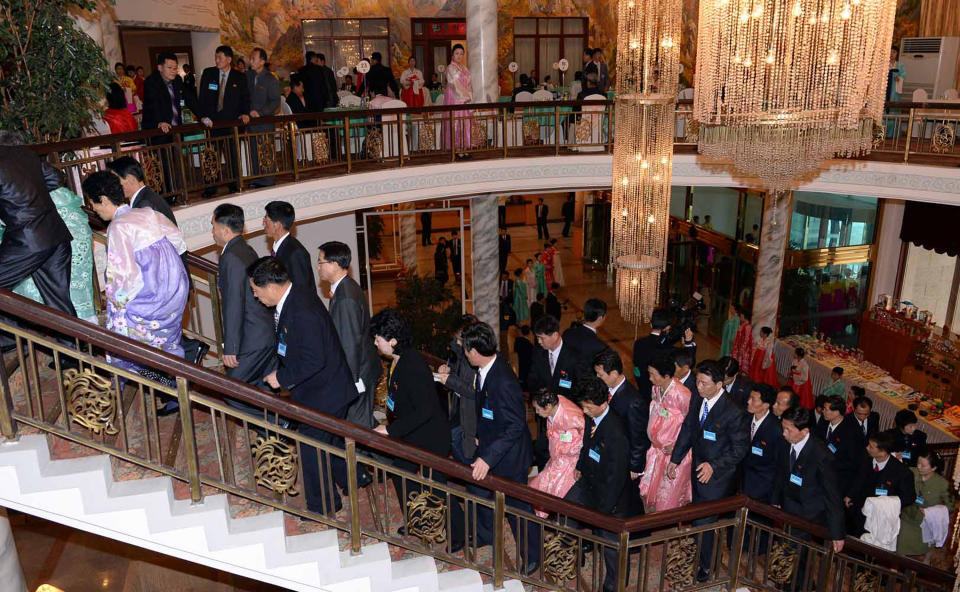 South and North Korean family members arrive to attend a dinner during the Separated Family Reunion Meeting at Diamond Mountain resort in North Korea, Thursday, Feb. 20, 2014. (AP Photo/Kim Ju-sung, POOL)