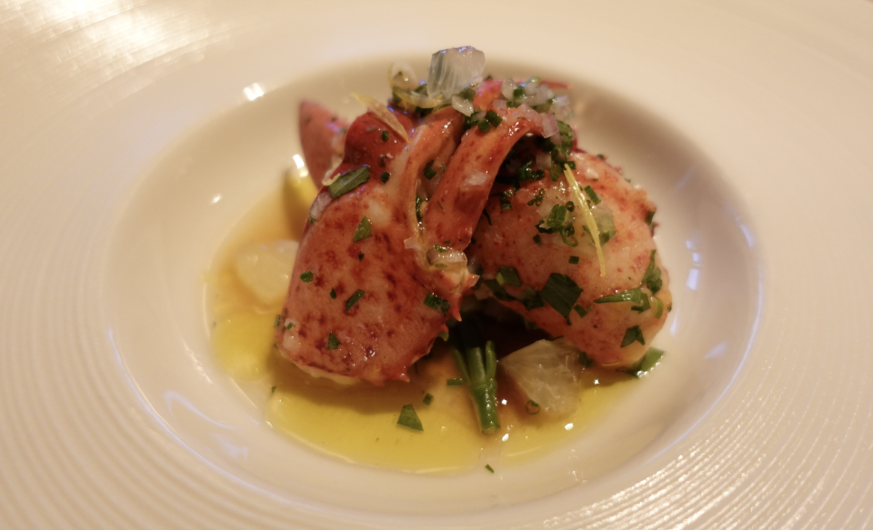 Tender, lightly poached Canadian lobster is served with small dices of fresh lemon, shellfish vinaigrette and sea asparagus
