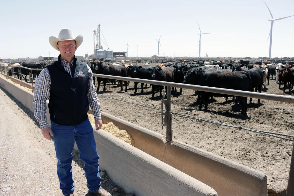 Robby Kirkland, owner of Kirkland Feedyard, standing in the middle of cow pens in Vega, TX.  The pandemic has cost the owners money in the stock market, but owner Robby Kirkland says he is grateful that his family and employees are healthy.