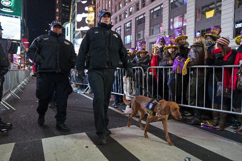 New York police officers walk among revelers who have gathered on Times Square in New York, Saturday, Dec. 31, 2016, to take part in a New Year's Eve celebration. (AP Photo/Craig Ruttle)