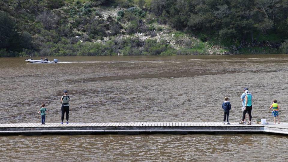 Families check out the high water levels at Lopez Lake on Friday, March 17, 2023. The lake was at 92.6% capacity and was expected to spill for the first time since 1999.
