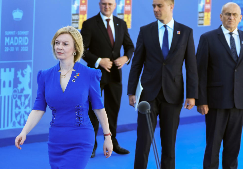 FILE - British Foreign Secretary Liz Truss, left, arrives for the NATO summit in Madrid, Spain on Wednesday, June 29, 2022. Britain's new leader, Liz Truss, is the child of left-wing parents who grew up to be an admirer of Conservative Prime Minister Margaret Thatcher. Now she is taking the helm as prime minister herself, with a Thatcherite zeal to transform the U.K. One colleague who has known Truss since university says she is “a radical” who wants to “roll back the intervention of the state” in people’s lives, just as Thatcher once did. (AP Photo/Paul White, File)