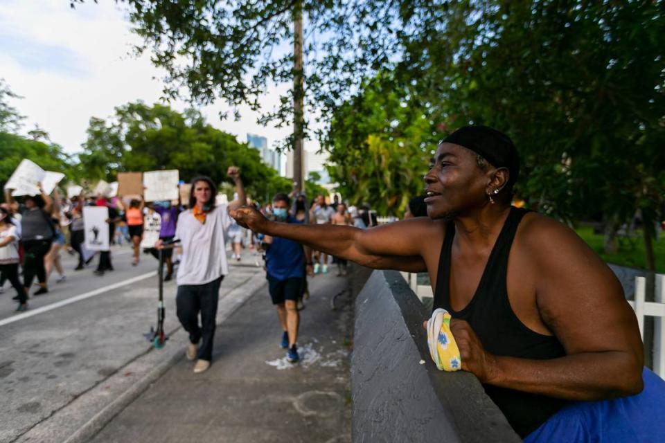 Rose McFarlen, right, cheers as activists march past her home in Overtown during a Justice for George Floyd protest on Monday, June 1, 2020.