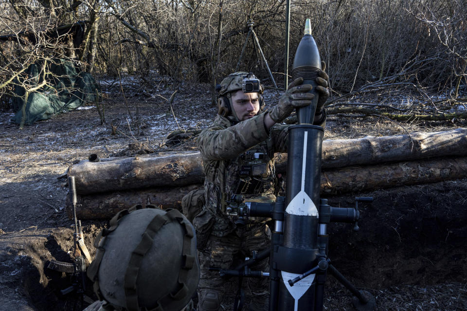 A Ukrainian serviceman prepares to fire a 120 mm mortar towards Russian positions at the frontline near Bakhmut, Donetsk region, Ukraine, Wednesday, Jan. 11, 2023. (AP Photo/Evgeniy Maloletka)