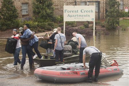 Residents of Forest Creek Apartments are rescued after heavy flooding in Pensacola, Florida, April 30, 2014. REUTERS/Michael Spooneybarger