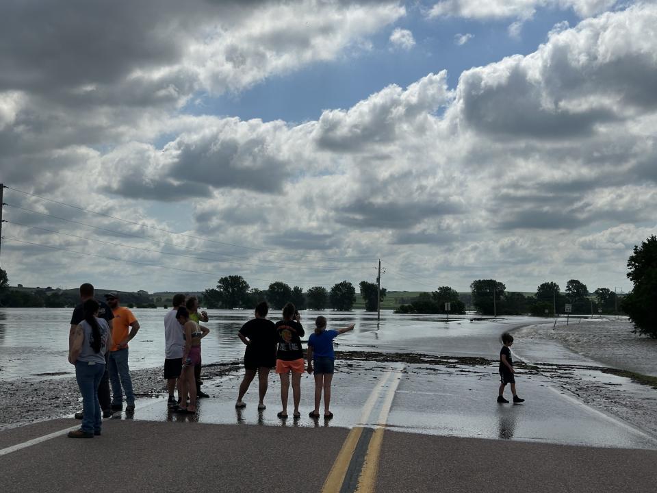 People look at the Little Sioux River as it overtops Highway 141 in Smithland, Iowa, on June 25, 2024.