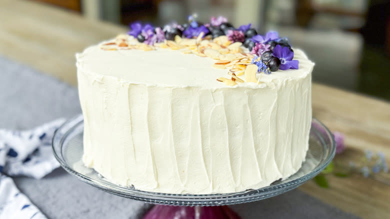 Blueberry and almond chantilly cake with fresh flower and blueberry garnish