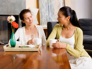 two women drinking coffee