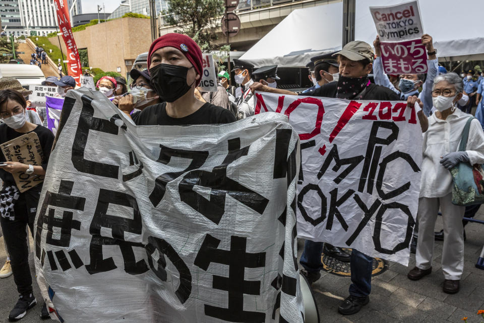 <p>Anti-Olympics protesters demonstrate during the Olympic Torch Relay Celebration event on July 23, 2021 in Tokyo, Japan. Protesters gathered to demonstrate against the Olympic Games amid concern over the safety of holding the event during the global coronavirus pandemic as well as the cost incurred. (Photo by Yuichi Yamazaki/Getty Images)</p> 