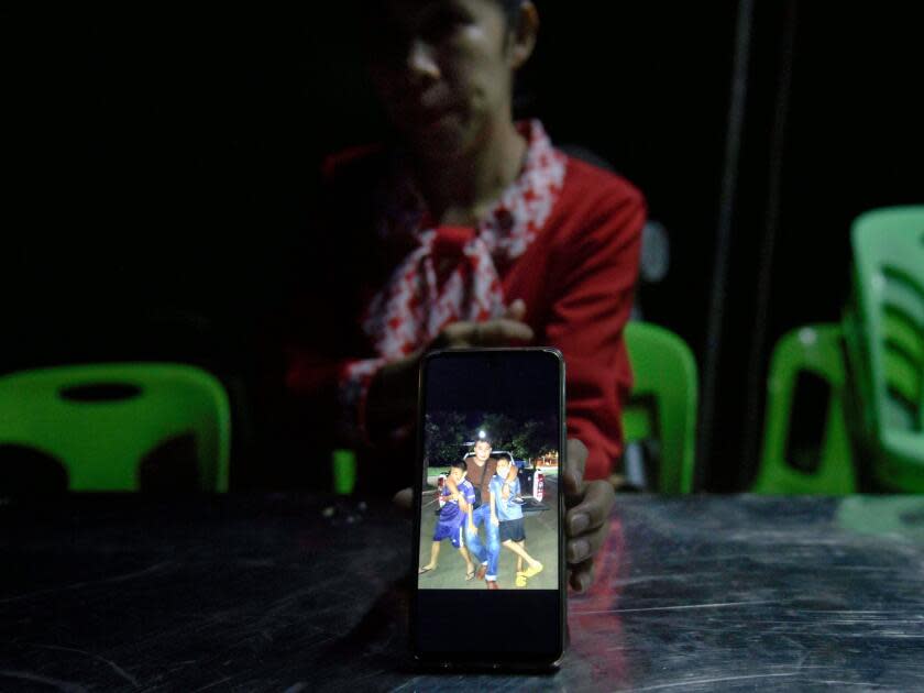 A woman shows a picture on her phone.