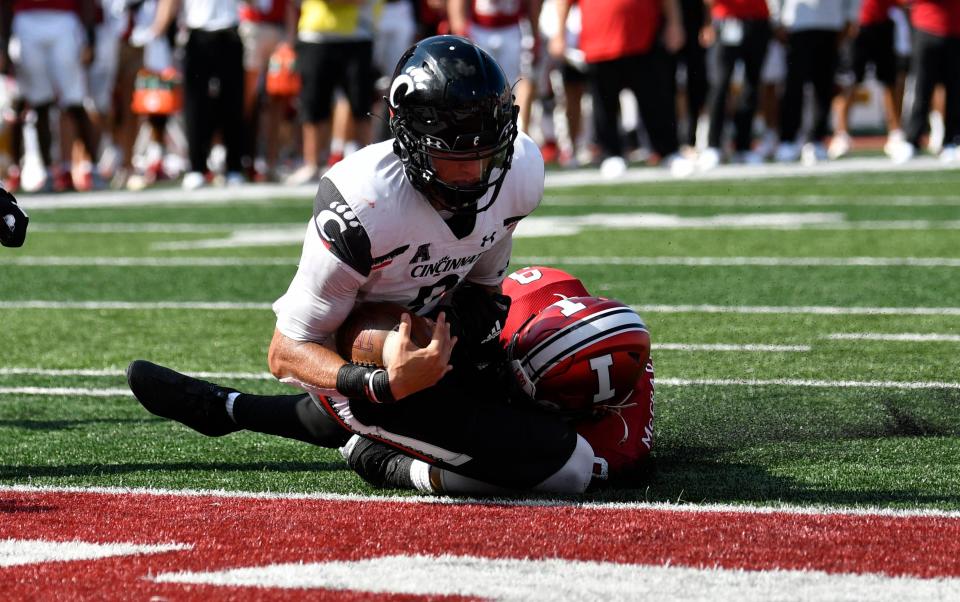 Bearcats quarterback Desmond Ridder tries to get away from Hoosiers defensive back Marcelino McCrary-Ball for a touchdown during the second half.