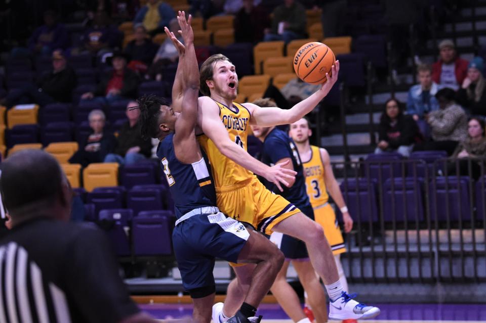 Hardin-Simmons' Aidan Walsh (0) fights through contact for a layup during Thursday's game against East Texas Baptist. The Cowboys snapped a three-game losing streak with the 84-75 victory.