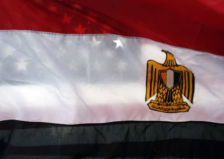 An American flag is seen behind an Egyptian flag at a rally against Egypt's President Hosni Mubarak outside the Federal Building in Westwood, California, January 29, 2011. Egypt's street protesters pushed Mubarak into naming a deputy who might in time succeed him, but thousands went on defying a curfew and urging the army to join them in forcing Mubarak from power immediately. REUTERS/Eric Thayer (UNITED STATES - Tags: POLITICS CIVIL UNREST) - RTXX9IF