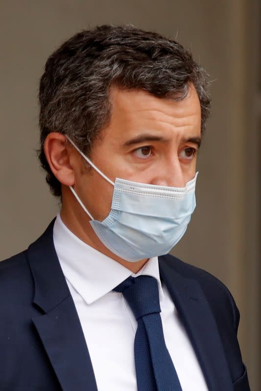 FILE PHOTO: French Interior Minister Gerald Darmanin, wearing a protective face mask, leaves after a weekly cabinet meeting