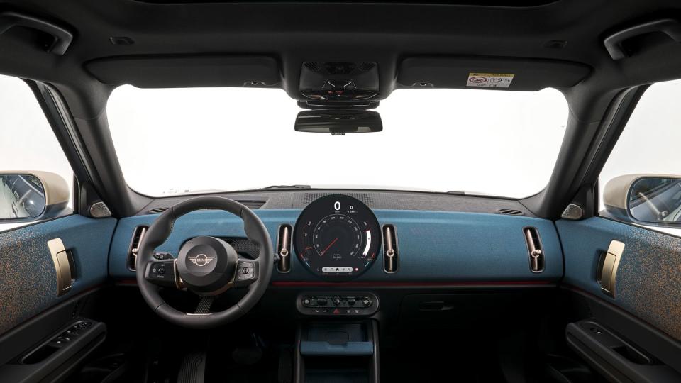 2025 mini cooper countryman electric in light blue with a brown and blue interior