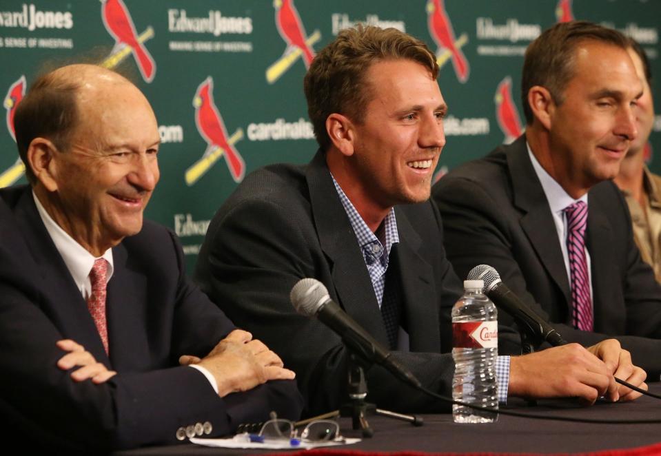 From left, St. Louis Cardinals Chairman Bill DeWitt, Stephen Piscotty, center, and team general manager John Mozeliak smile during a press conference after signing Piscotty to a long term contract, during a press conference Monday, April 3, 2017, in St. Louis. (J.B. Forbes/St. Louis Post-Dispatch via AP)