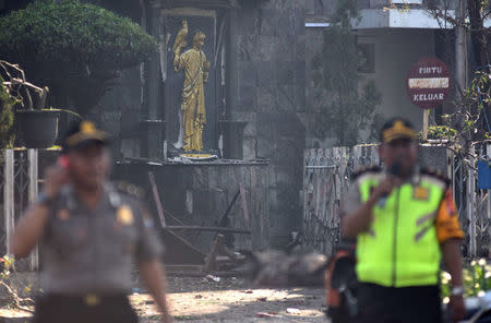 Police are seen outside the Immaculate Santa Maria Catholic Church following a blast, in Surabaya, East Java, Indonesia May 13, 2018 in this photo taken by Antara Foto. Antara Foto/M Risyal Hidayat / via REUTERS